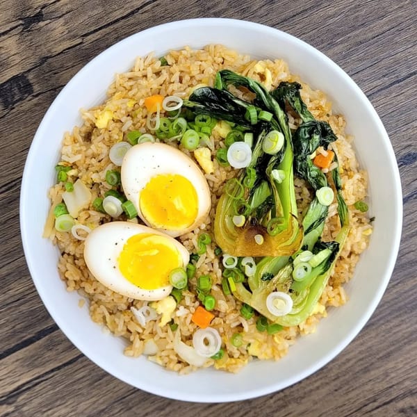 Brooklyn Dim Sum Co's fried rice with bok choy, sliced green onions, and two soft-boiled eggs.